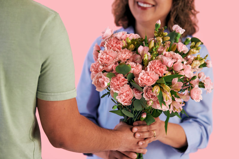Pastel pink flower bouquet with a pastel pink background