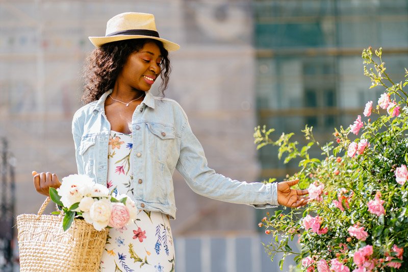 woman with a basket of flowers in full bloom