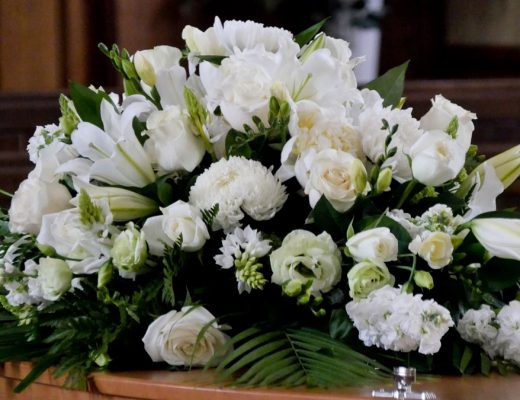 funeral casket flower arrangement with white flowers