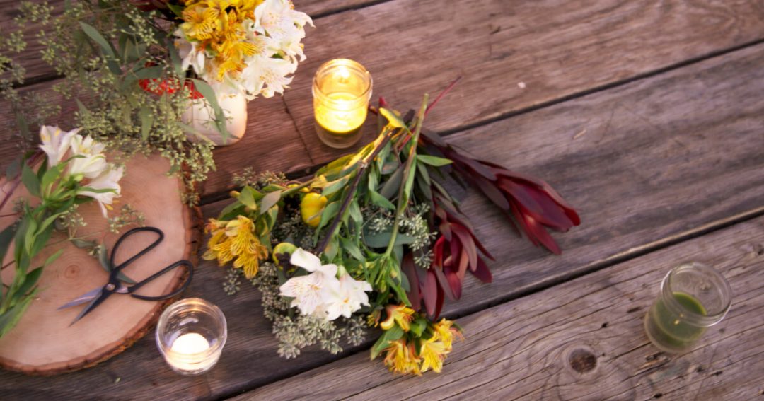 Cut flowers on a table with candles