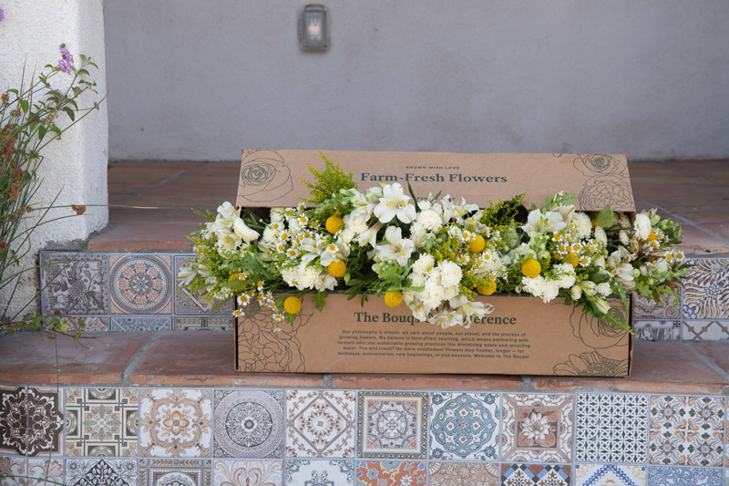 white and yellow bouquet in The Bouqs Co. delivery box