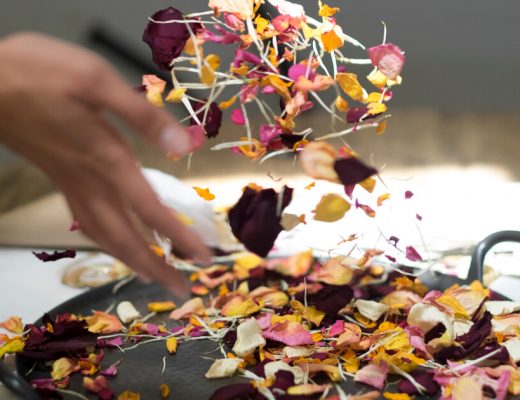 Person throwing dried flowers into the air.