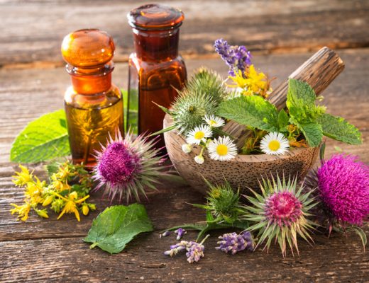 flowers with tincture bottle and wood mixing bowl