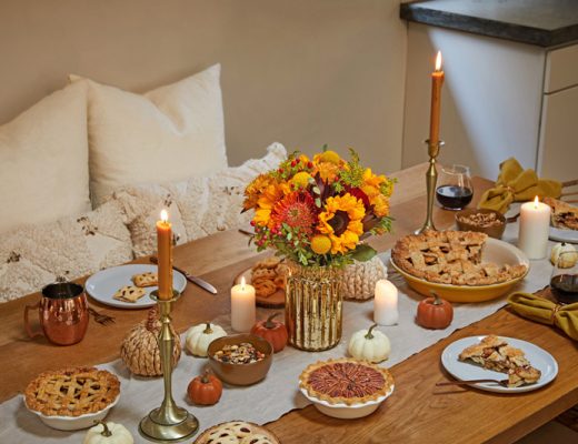 orange yellow fall centerpiece at dinner table with pumpkin pie