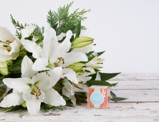 White Lilies in a Bouquet with Orange Sugarfina Champagne Bears in a Clear Box Gifts for Co-Workers