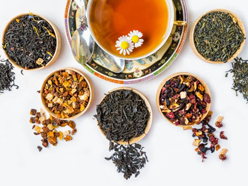 Soup with flowers with spice bowls filled with different herbs.