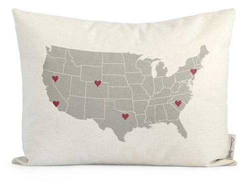 Pillow with a map of the USA with hearts in different locations.
