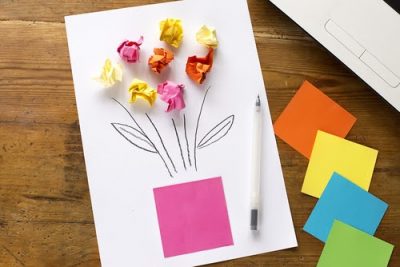 Paper pom pom flowers in pink, orange, and yellow