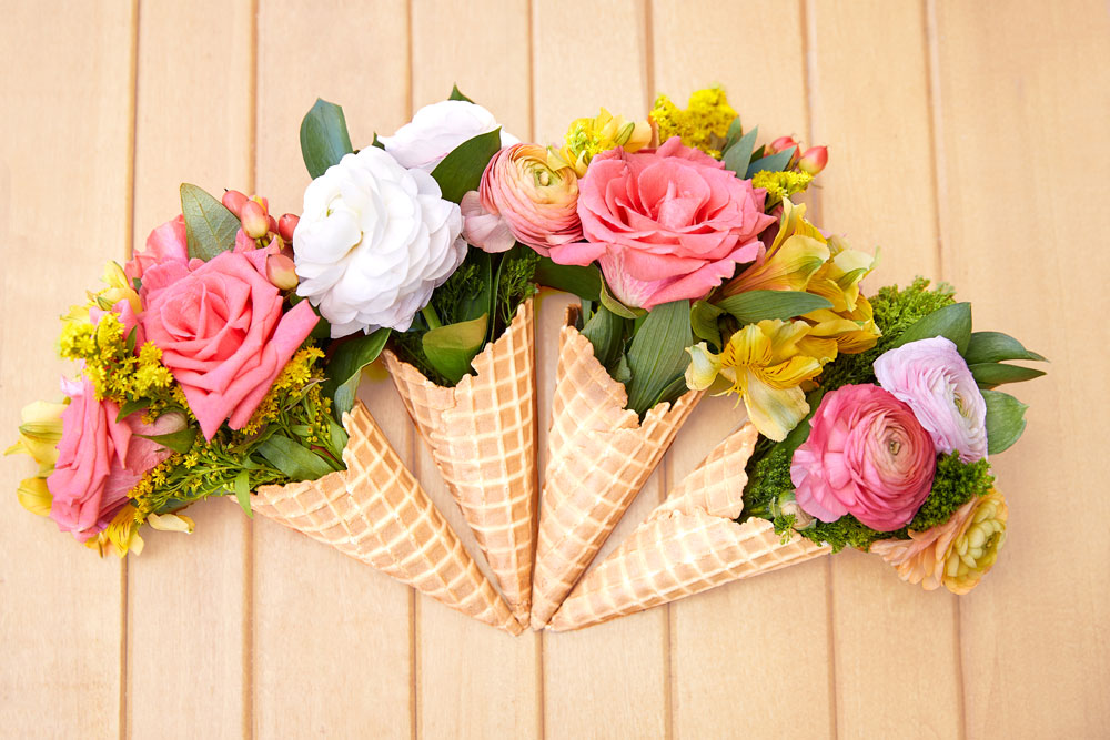 Flower bouquet displayed in waffle cones for friends
