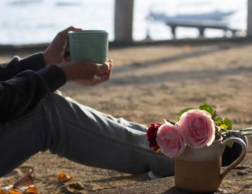 flowers and coffee at the beach on self care day