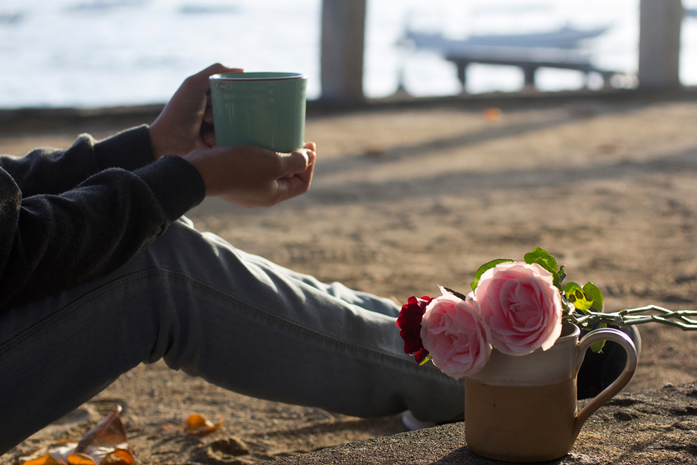 flowers and coffee at the beach on self care day
