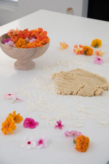 Cookie dough and edible flowers ready to make cookies