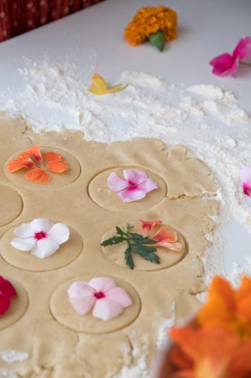 Edible flowers placed on the cookie dough