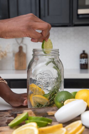 Dropping lime slices into the mason jar