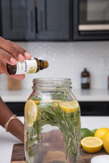 Dropping droplets of citronella essential oils into the mason jar filled with water