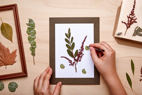 Woman Making a Decoration With Pressed Flowers