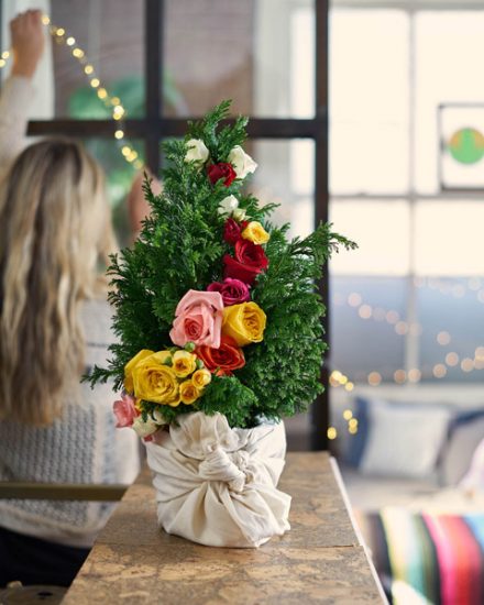 mini christmas tree with fresh flower decorations