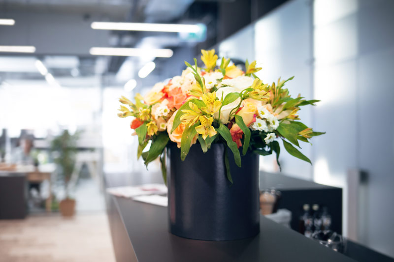 yellow and white flower arrangement in an office