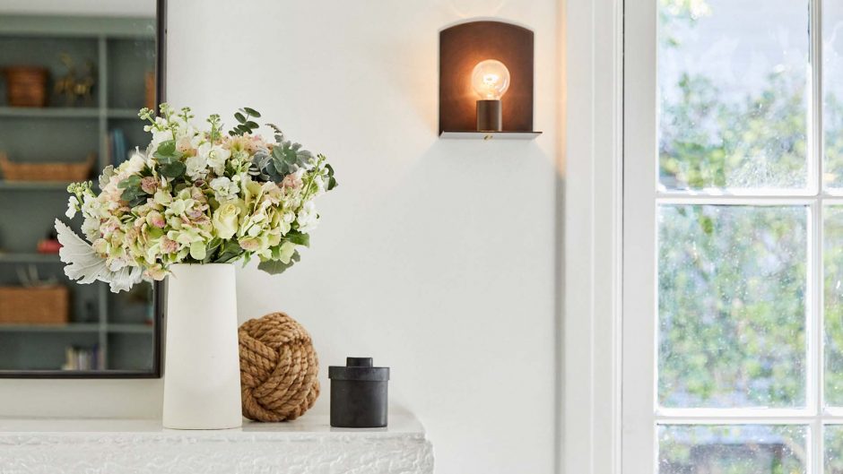 white and ivory flowers in a white vase on a kitchen counter