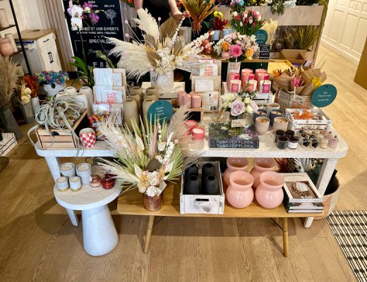 Retail merchandising display with candles, books, dried flowers , vases and more