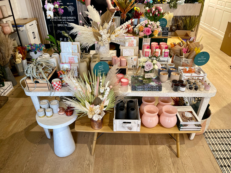 Retail merchandising display with candles, books, dried flowers , vases and more