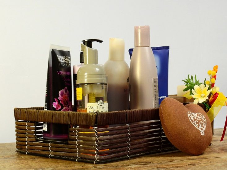 basket filled with bottles of lotions and bath supplies
