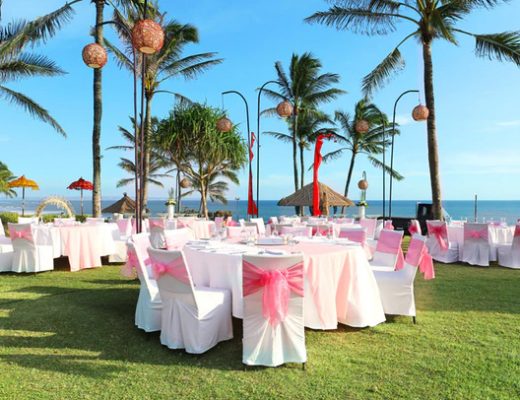 wedding tables set up on the beach overlooking an ocean