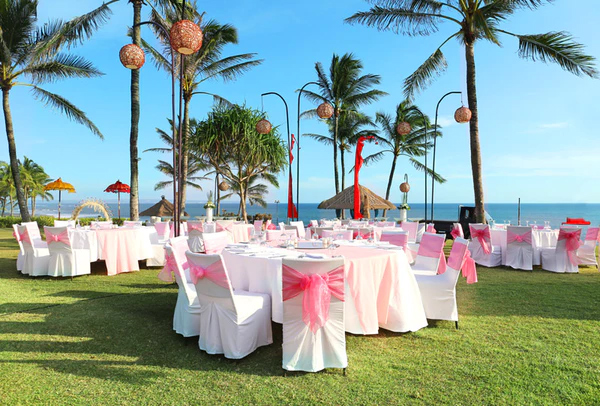 wedding tables set up on the beach overlooking an ocean