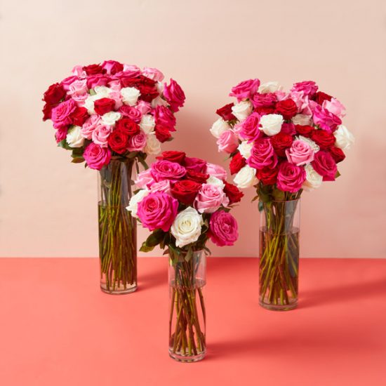three vases of long-stem multi-colored roses