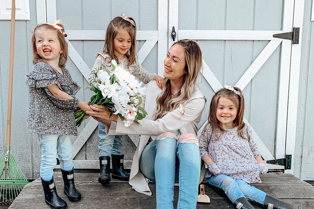 mom sharing flowers with happy kids