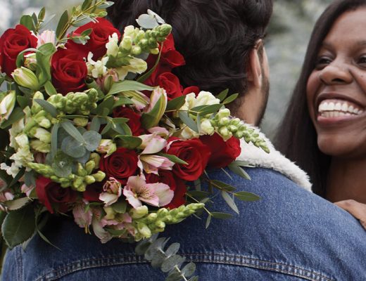 man and women holding flowers for valentines day