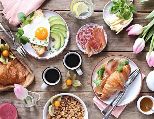 Brunch spread with pink tulips features on the table