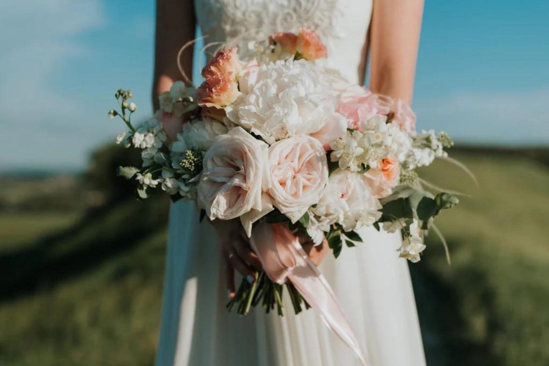 Bride holding a wedding bouquet of flowers