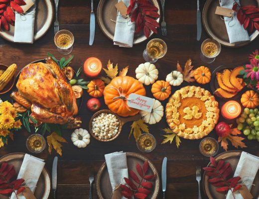 A Thanksgiving dinner table arranged with food and plates