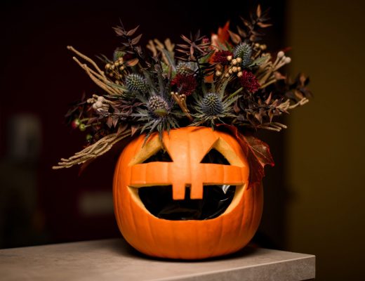 Jack-o-lantern filled with dark flowers for Halloween