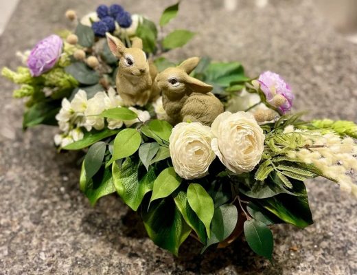 Centerpiece of flowers and bunny statues for Easter