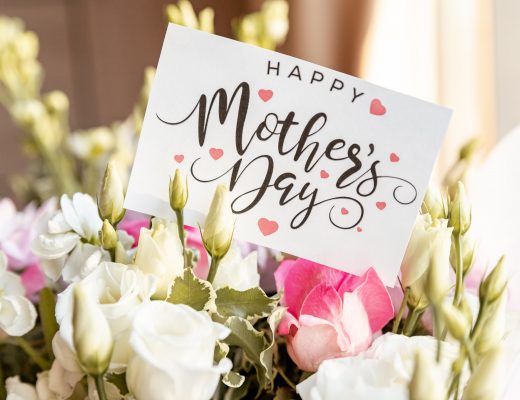 A card reading "Happy Mother's Day" sits in a bouquet of flowers