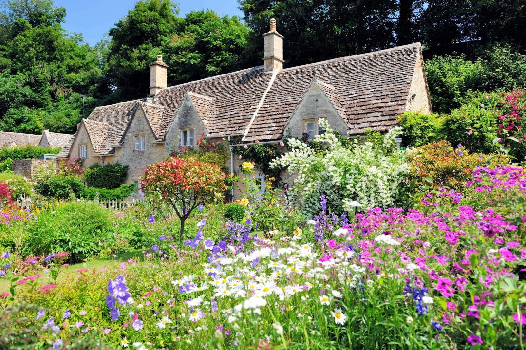 Cottage with beautiful floral landscape in front