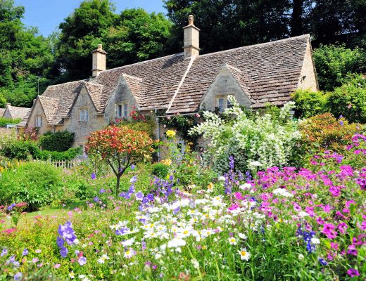 Cottage with beautiful floral landscape in front