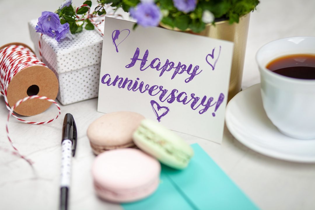 Happy anniversary card with treats and gifts around it