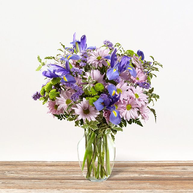 Floral display with blue, lavender, and purple flowers.