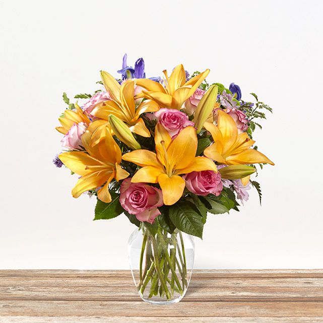 Floral display with orange, yellow, and pink flowers.