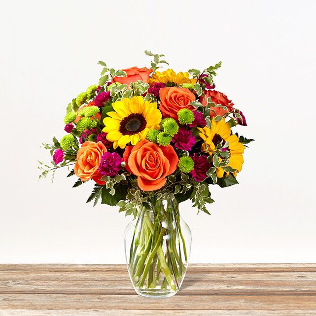 Mulicolored flower bouquet in orange, yellow, lavender and green.