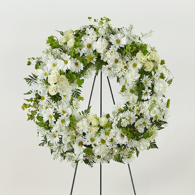 Standing funeral wreath of white and green mixed flowers