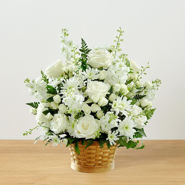 Sympathy basket full of white flowers 